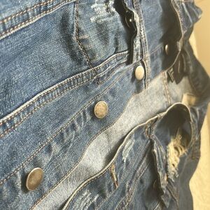 Ripped royal blue jean jacket , patched and stitched with pockets